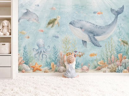 Watercolor under the sea nursery wall mural with whale, dolphin, turtle, octopus, and coral reef in soft blue coastal tones
